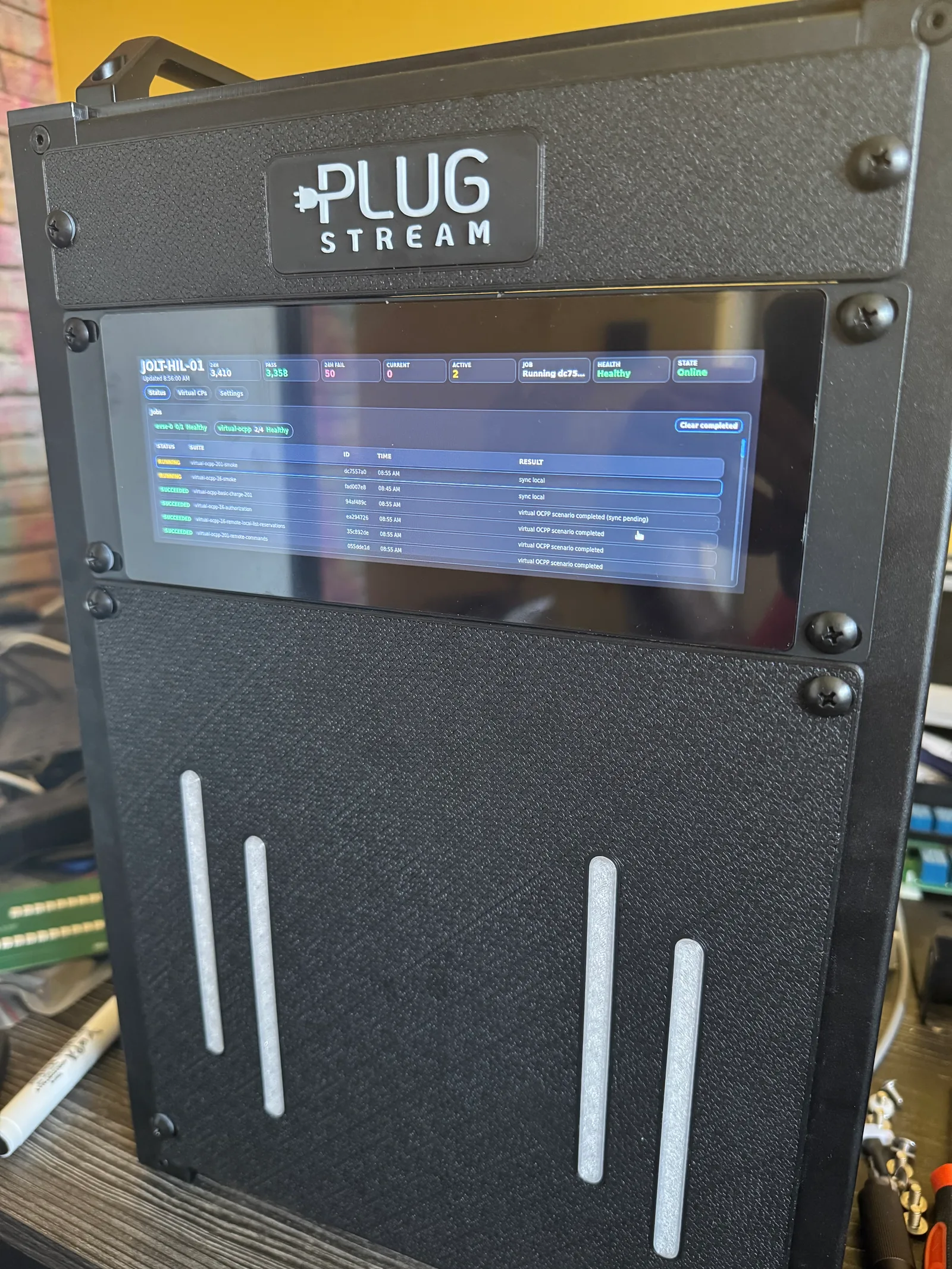 PlugStream HIL rig enclosure with integrated status screen and EVSE board bays