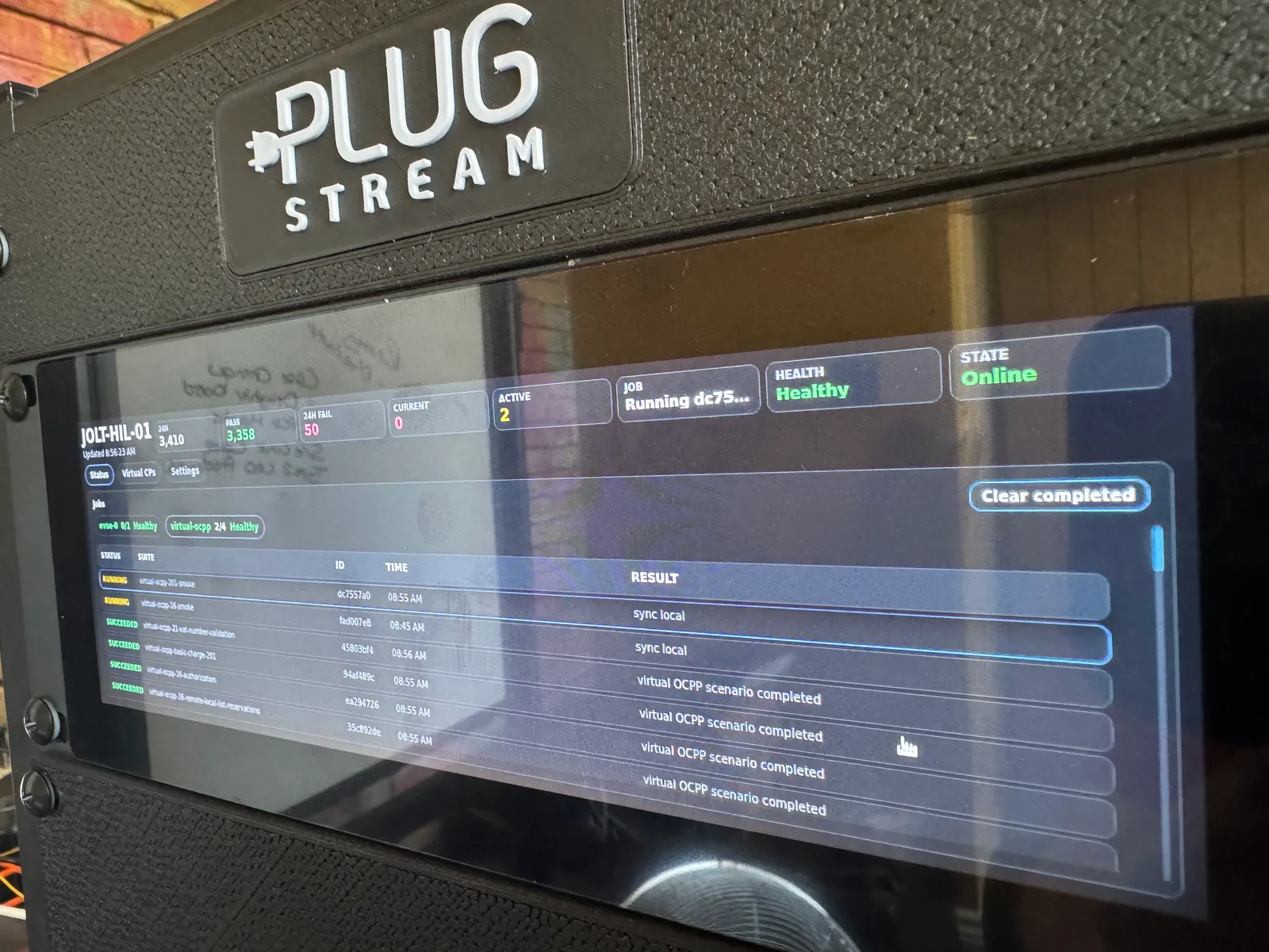 PlugStream HIL rig status panel showing automated jobs, health state and virtual OCPP results